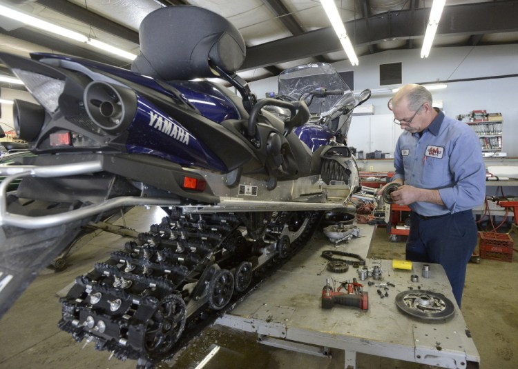 Richard Diekema works on a snowmobile at Reynolds Motorsports in Buxton in March of 2015. The company said on its Facebook page, "Rich Diekema was more than a co-worker. He was a great friend to many and will be missed by everyone who knew him.” 
File photo/John Patriquin
