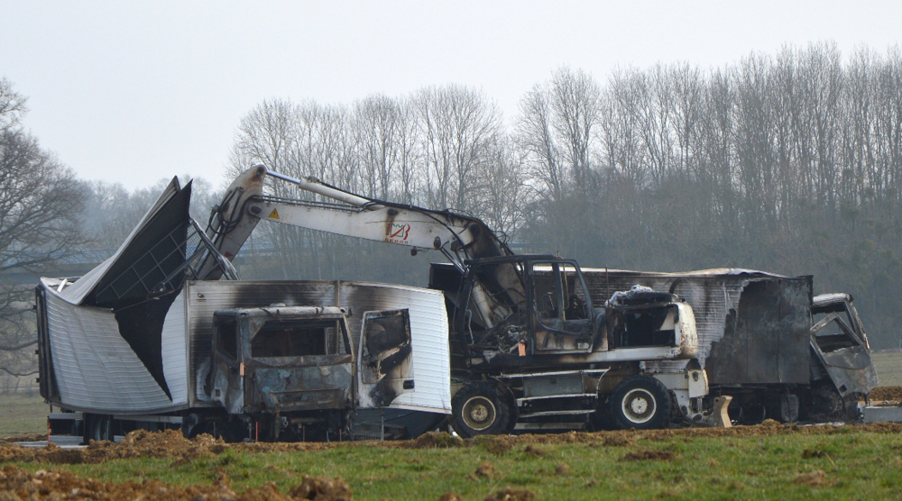 A police official says that 15 armed assailants attacked two vans carrying jewels worth millions on a French highway and sped away. The vans were found burned.