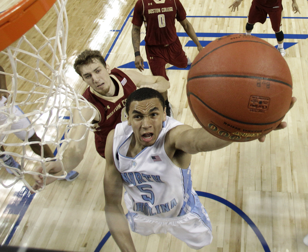 North Carolina’s Marcus Paige drives past Boston College’s Eddie Odio in Wednesday’s second-round ACC tournament game in Greensboro, N.C. The Tar Heels advanced with an 81-63 win.