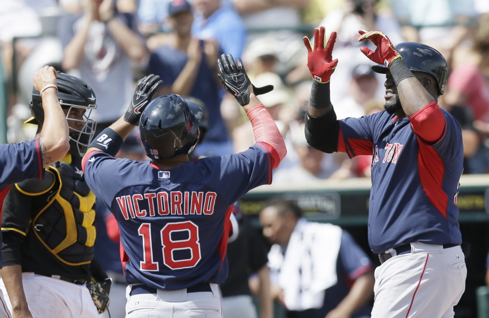 Red Sox designated hitter David Ortiz, right, is congratulated by Shane Victorino after hitting a three-run homer in the third inning of a spring training victory over the Pirates on Thursday.
