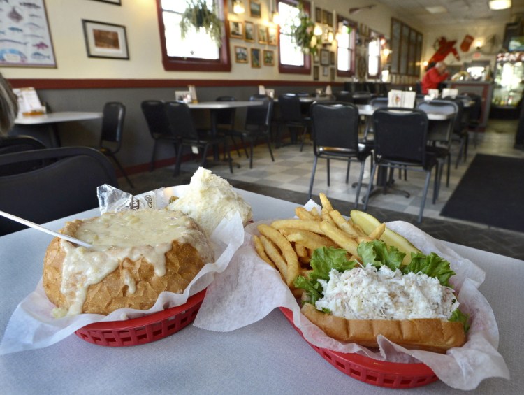 Clam chowder in a bread bowl and a crab meat roll with fries at Gilbert’s Chowder House.
