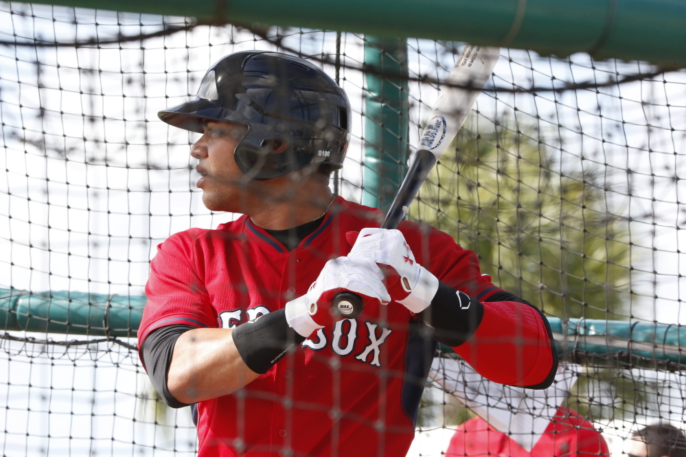 Boston Red Sox' Yoan Moncada bats during practice at spring training baseball Friday in Fort Myers Fla. The Red Sox finalized a minor league contract with the 19-year-old Cuban infielder that includes a $31.5 million signing bonus, easily a record for an international amateur free agent under 23 years old. The Associated Press