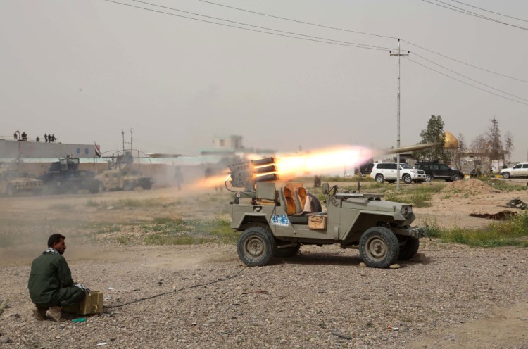 A member of an Iraqi Shiite militant group called Soldiers of Imam Ali Brigades launches rockets Friday against Islamic State extremist positions in Tikrit. Iraqi forces entered Tikrit for the first time on Wednesday from the north and south. On Friday, they fought fierce battles to secure the northern Tikrit neighborhood of Qadisiyya.
The Associated Press