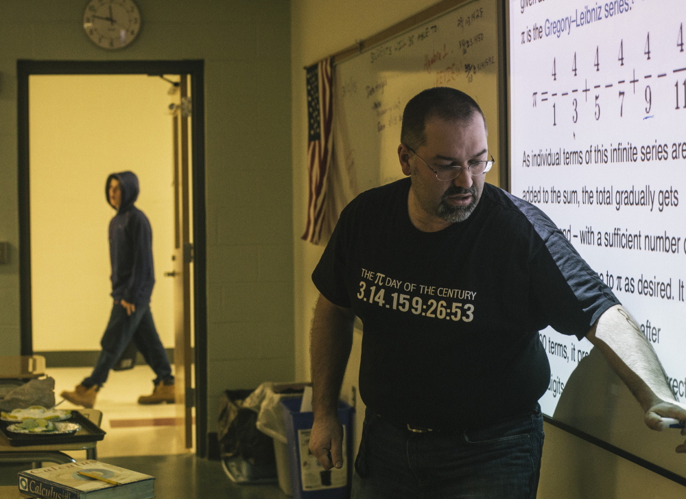 Biddeford High School math teacher Jon Jacques instructs his calculus class while wearing a shirt with some of the numbers of pi written out in 2015.