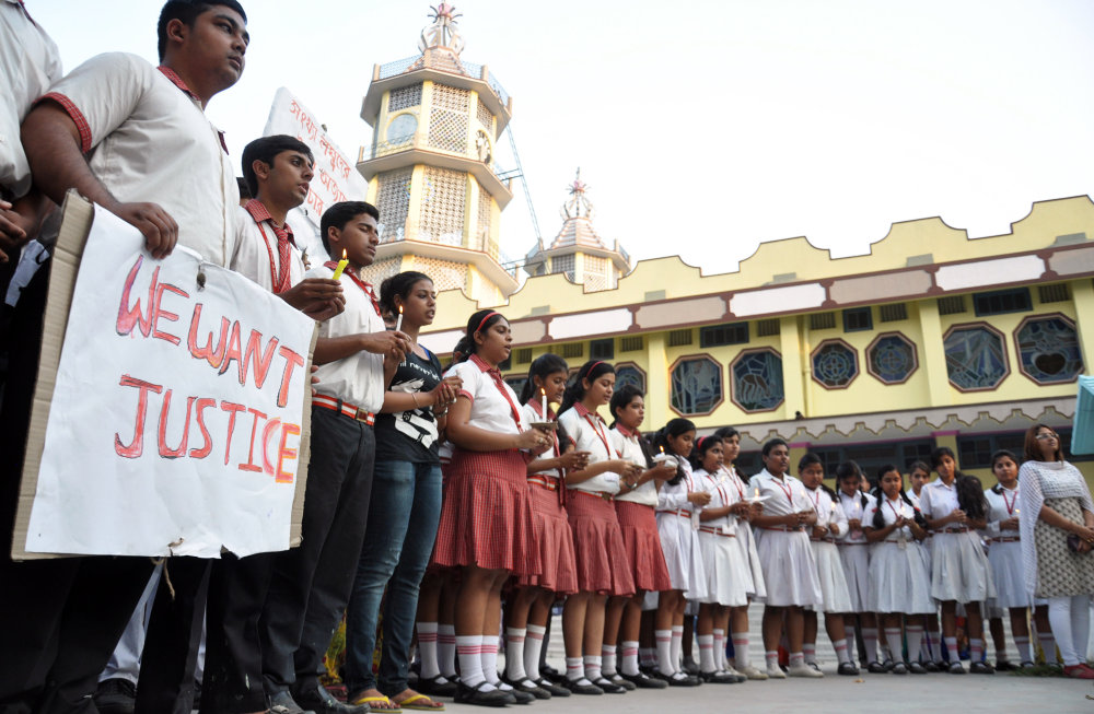Students of Convent of Jesus and Mary School participate in a protest against the gang rape of a nun in her 70s by a group of bandits when she tried to prevent them from robbing the Christian missionary school in Begopara, about 80 kilometers (50 miles) northeast of Kolkata, the capital of West Bengal state, Saturday, March 14, 2015. The nun was hospitalized in serious condition after the attack, which was committed by seven or eight men. The woman who was attacked is either 71 or 72 and is the oldest nun at the school, a police officer said. (AP Photo/Pranab Debnath)