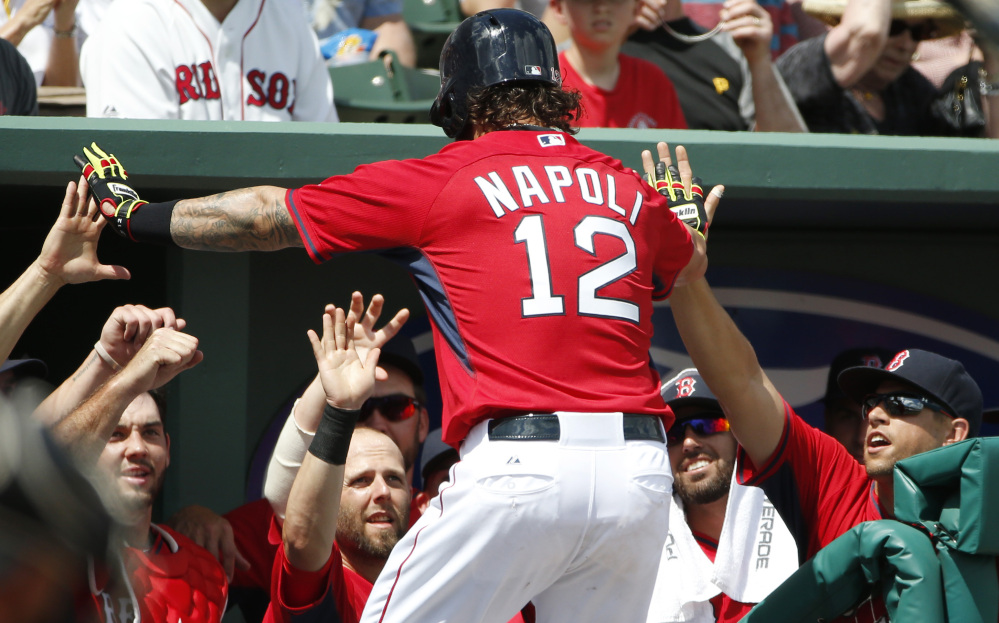 Mike Napoli is congratulated in the dugout after a solo home run in the fourth inning Saturday. Napoli, who had an eight-hour surgery for sleep apnea in the offseason, homered twice.
