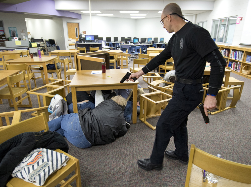 Independence, Mo., police hold an active-shooter training session for the staff of Pioneer Ridge Middle School. In their first scenario, the staff was told to just take cover. This allowed the gunman, played by Sgt. Chris Summers, to “kill” many victims. Tribune News Service