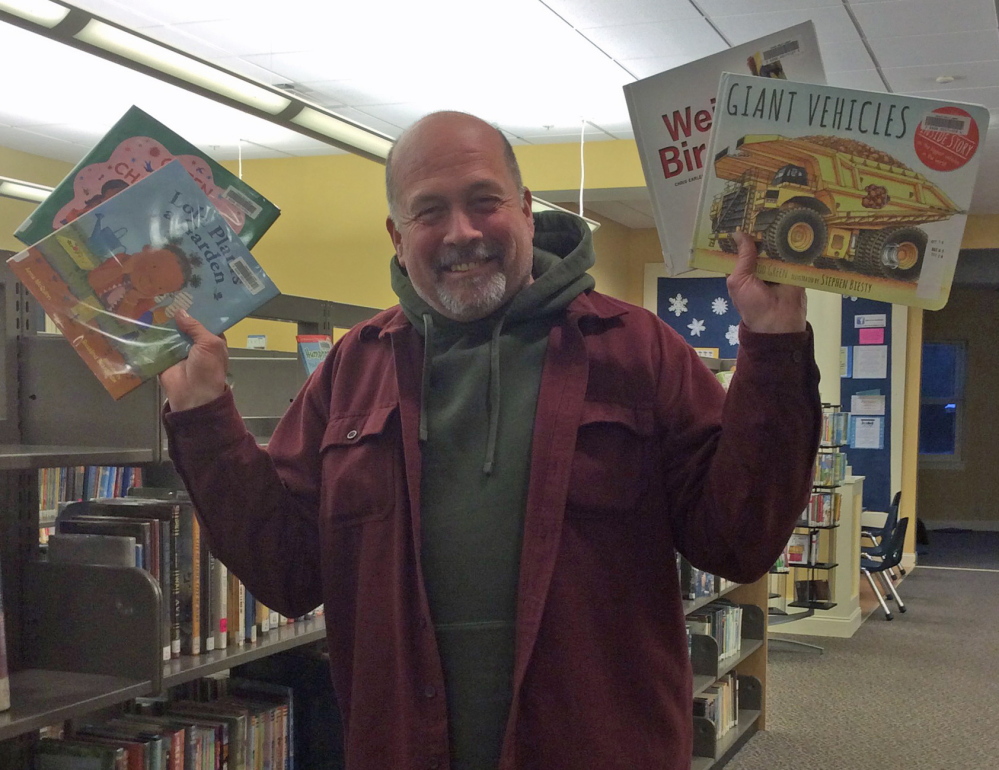 Bus driver Donald Sanders holds a selection of children’s books that are getting a lot of mileage as part of the Bus Book Bags program in SAD 75.