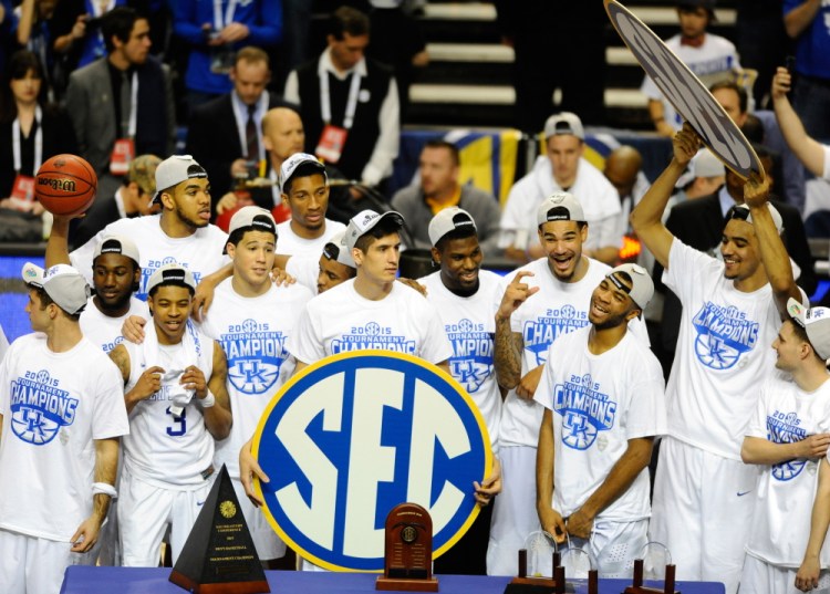 The Kentucky Wildcats celebrate after winning the SEC tournament championship on Sunday. The Wildcats are 34-0 and earned the top seed in the NCAA Division I men’s basketball tournament.