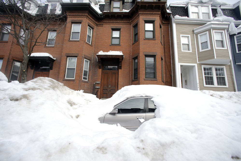Snow buries a along a residential street in South Boston on Feb. 23. Boston’s miserable winter is now also its snowiest season going back to 1872.