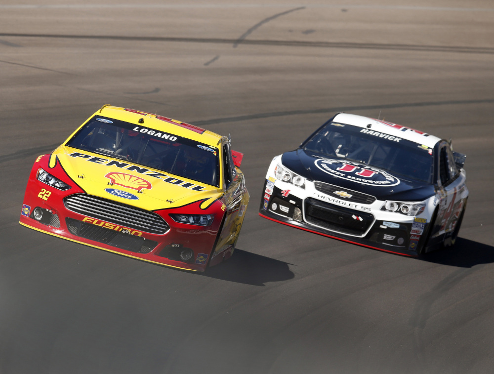 Joey Logano, left, leads Kevin Harvick early, but Harvick did what he often does at Phoenix International Speedway, he took over the lead and won for the fourth straight race at the track Sunday.