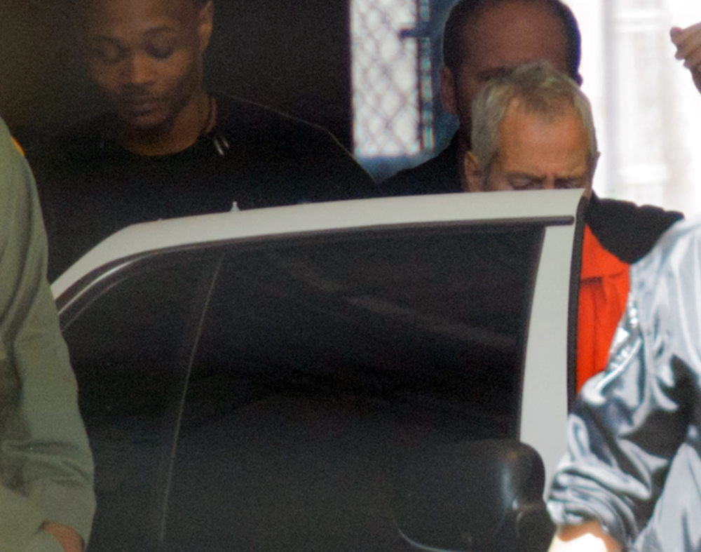 Robert Durst is escorted from Orleans Parish Criminal District Court in New Orleans on Monday. Durst, a millionaire from one of America’s wealthiest families, agreed Monday to return to Los Angeles to face a 15-year-old murder charge after muttering that he “killed them all” in a documentary about his links to three sensational killings.