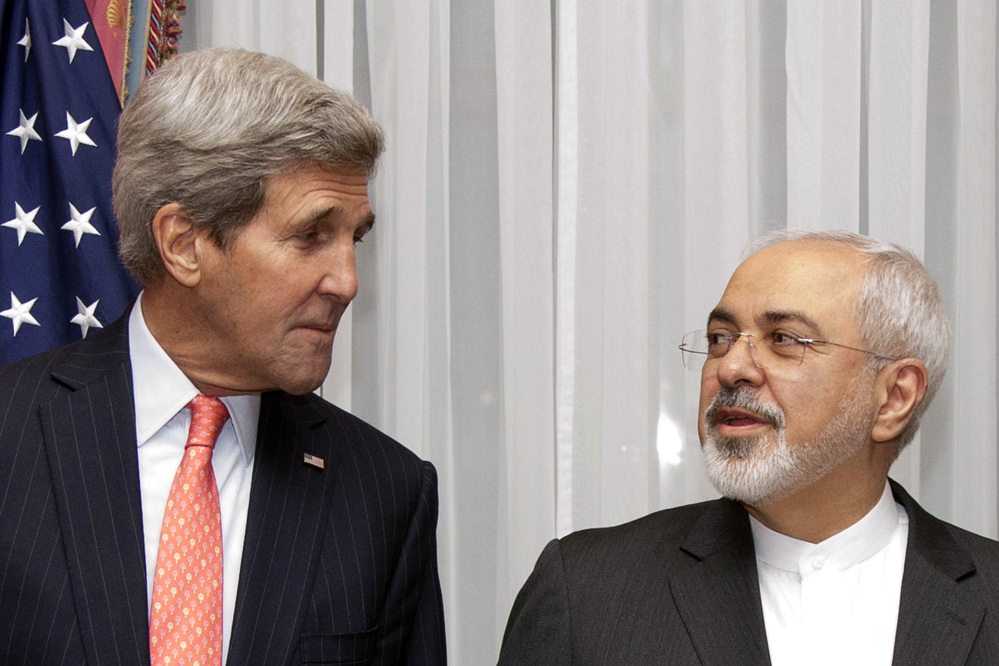 U.S. Secretary of State John Kerry, left, listens to Iran’s Foreign Minister Mohammad Javad Zarif, right, before resuming talks over Iran’s nuclear program in Lausanne, Switzerland, Monday, March 16, 2015. The United States and Iran are plunging back into negotiations in a bid to end a decades-long standoff that has raised the specter of an Iranian nuclear arsenal, a new atomic arms race in the Middle East and even a U.S. or Israeli military intervention. (AP Photo/Brian Snyder, Pool)