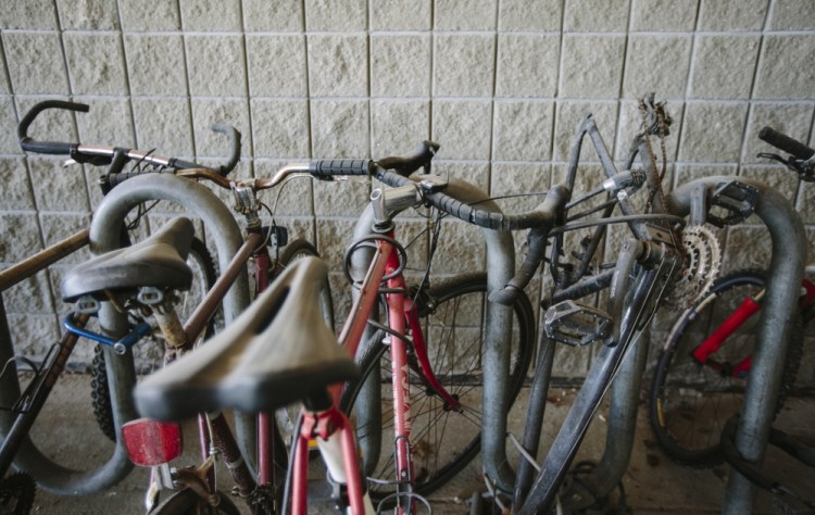 Bikes, many broken or lacking parts, sit at the Casco Bay Ferry Terminal in Portland.