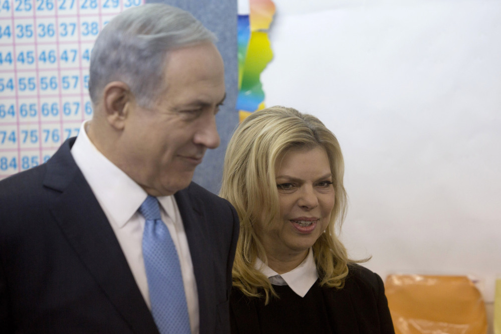 Israeli Prime Minister Benjamin Netanyahu stands with his wife Sara after voting in Israel’s parliamentary elections in Jerusalem, Tuesday.