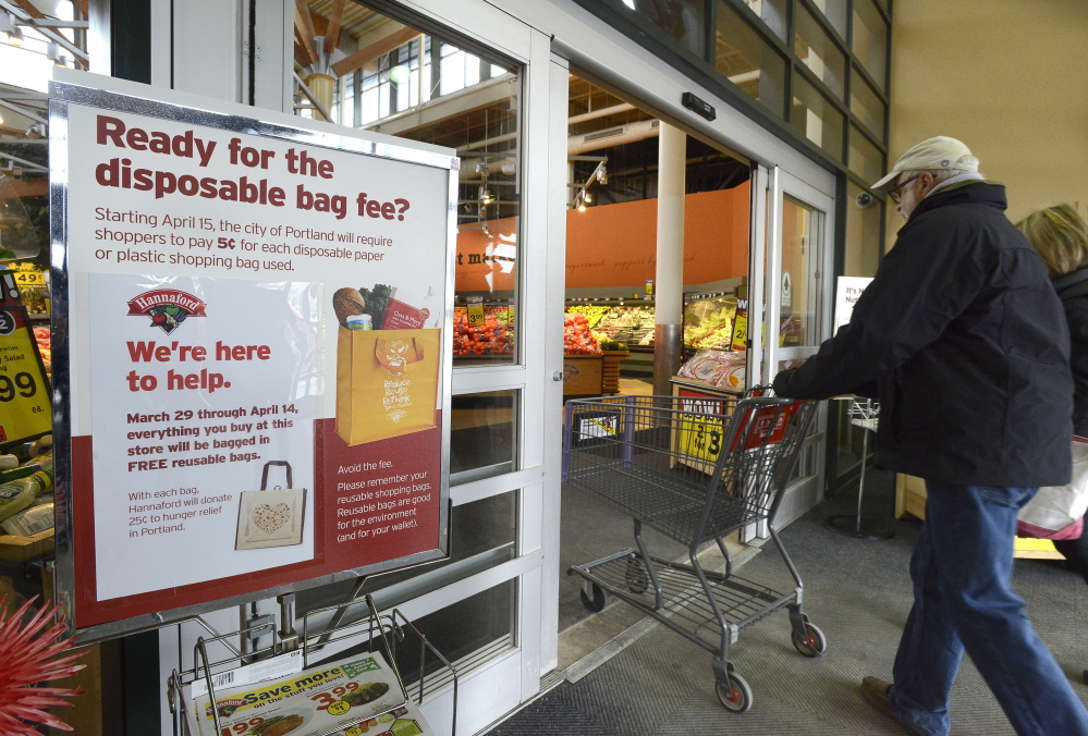 A sign alerts customers at the Hannaford store on Forest Avenue about the disposable bag fee arriving April 15. Hannaford expects to give away about 100,000 reusable bags, and all of the disposable bag fees paid at its two Portland stores will be donated to hunger relief.
