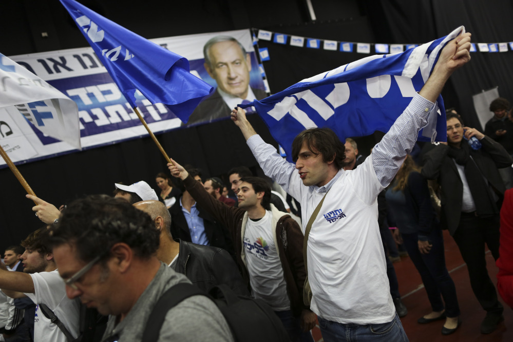 Israeli Prime Minister Benjamin Netanyahu Likud party supporters react to exit poll results at the party’s election headquarters In Tel Aviv on Tuesday.