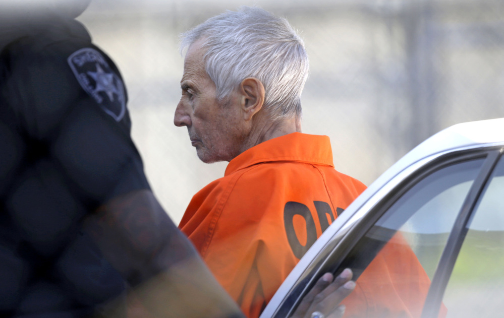 Robert Durst is escorted into Orleans Parish Prison after his arraignment in Orleans Parish Criminal District Court in New Orleans, Tuesday, March 17, 2015.  Durst was rebooked on charges of being a convicted felon in possession of a firearm, and possession of a weapon with a controlled dangerous substance, a small amount of marijuana.  (AP Photo/Gerald Herbert)