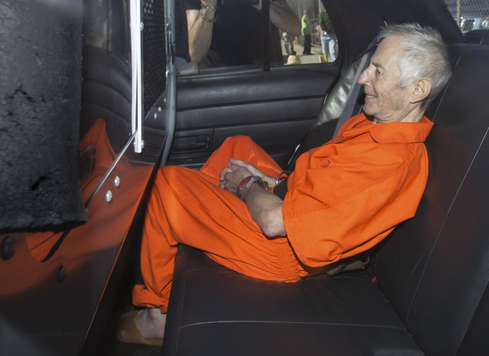 Robert Durst sits in a police vehicle as he leaves a courthouse in New Orleans, Louisiana March 17, 2015.  Durst, scion of one of New York's largest real estate empires, was charged on gun and drug charges, after he was arrested in New Orleans on a murder warrant issued by Los Angeles County Saturday. REUTERS/Lee Celano (UNITED STATES  - Tags: CRIME LAW) - RTR4TPV7