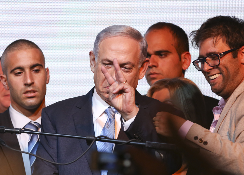 Israeli Prime Minister Benjamin Netanyahu greets supporters at the party’s election headquarters in Tel Aviv on Wednesday. The Likud Party’s decisive victory in Tuesday’s elections marked a stunning comeback in a tight race that had Netanyahu in political jeopardy.