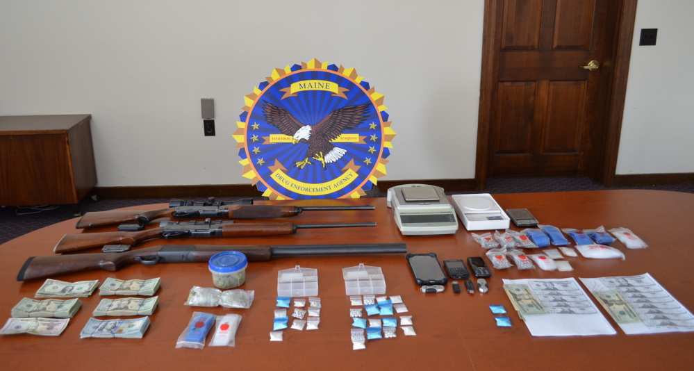Police display items seized from the home of Travis Hewitt in Caribou on Monday.