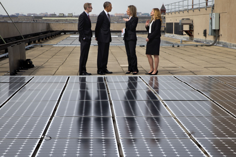 President Obama tours solar panels on the roof of the Energy Department in Washington on Thursday. Under Obama’s executive order, the government must cut energy use in federal buildings by 2.5 percent every year through 2025.