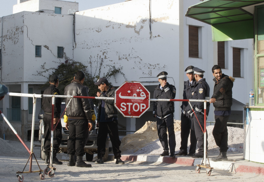 Tunisian police officers guard the entrance of the morgue of the Charles Nicolle hospital in Tunis on Thursday. The Islamic State Group claimed responsibility Thursday for the attack on a famed Tunis museum that left 23 people dead.