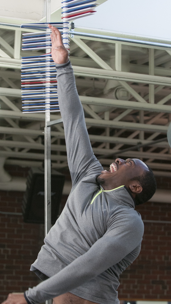 Recent UMaine graduate Damarr Aultman stretches to reach the highest point he can during a vertical jump test during Pro Day in Orono. He set a personal best of 41 inches.