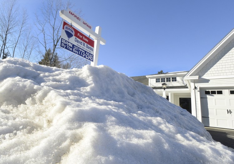 Mounds of snow linger Thursday at a Falmouth property listed for sale by David Banks, a Realtor with RE/MAX by the Bay in Portland. Pending home sales in Maine were down 4.1 percent in February compared with one year earlier, according to a RE/MAX report issued this week.