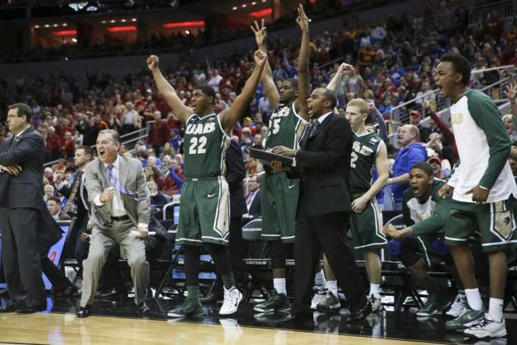The University of Alabama at Birmingham bench cheers after guard Robert Brown hit a 3-point basket in the closing seconds of the second half against Iowa State in the second round of the NCAA college basketball tournament in Louisville, Ky., on Thursday. UAB won the game 60-59.