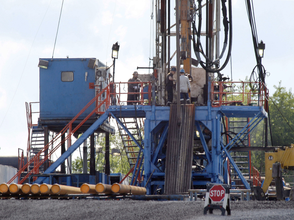 A crew works on a gas drilling rig at a well site for shale based natural gas in Zelienople, Pa. The Obama administration is requiring companies that drill for oil and natural gas on federal lands to disclose chemicals used in hydraulic fracturing operations. 