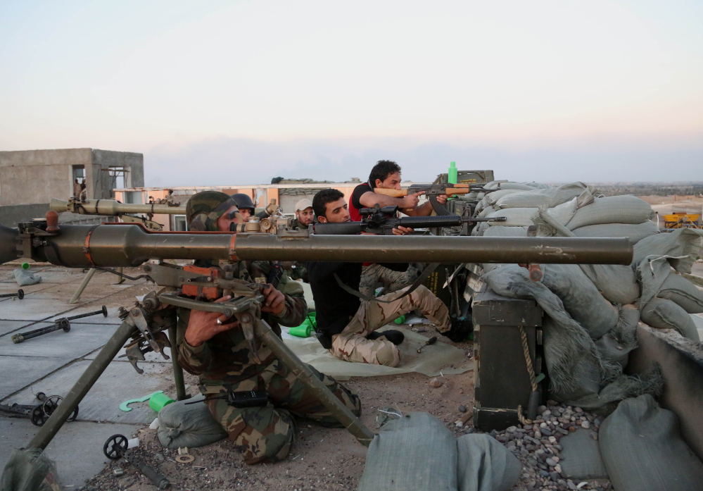 Iraqi security forces and allied Shiite militiamen battle Islamic State fighters in Tikrit last Sunday. The government and the militias are reported to be divided over tactics in the operation.