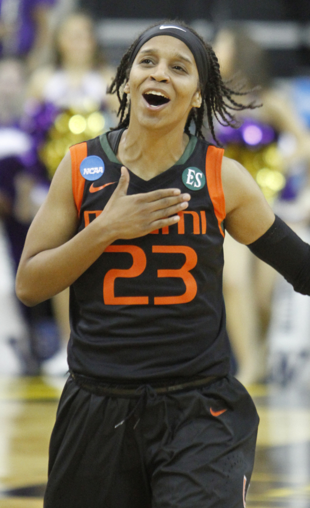 Miami’s Adrienne Motley celebrates as she runs off the court after the Hurricanes’ upset win over No. 6 Washington on Friday.