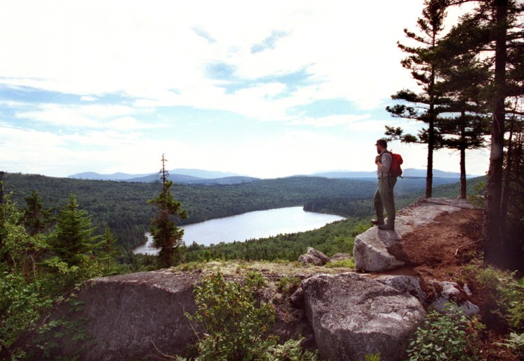 A Maine forester overlooks Sing Sing Pond along the Turtle Ridge Trail in the Nahmakanta Lake region between Moosehead Lake and Baxter State Park. 