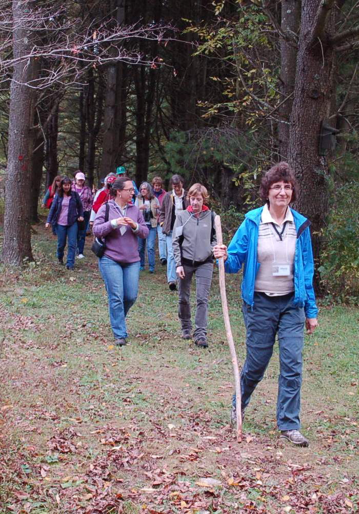 A group of women takes a walk along the Wells Reserve campus trails system. A similar outing is planned Wednesday as part of a women’s woodlot stewardship workshop being offered there.