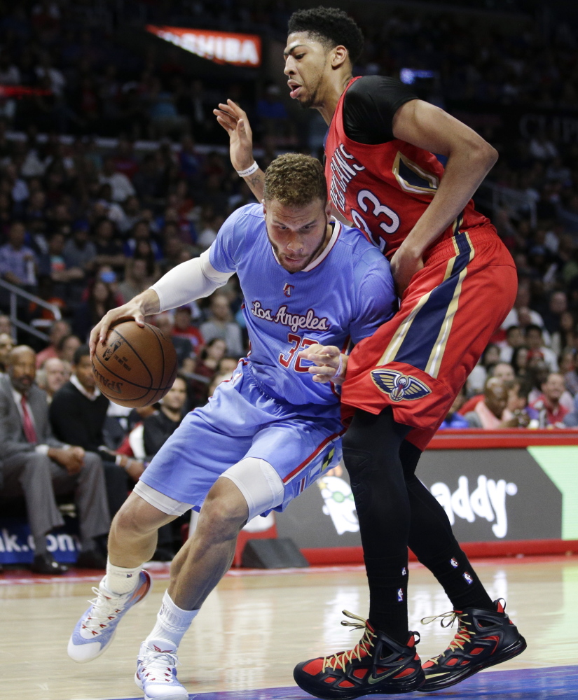 Blake Griffin of the Clippers drives against Anthony Davis of the Pelicans during Sunday’s game in Los Angeles. Griffin scored 23 points in a 107-100 victory.