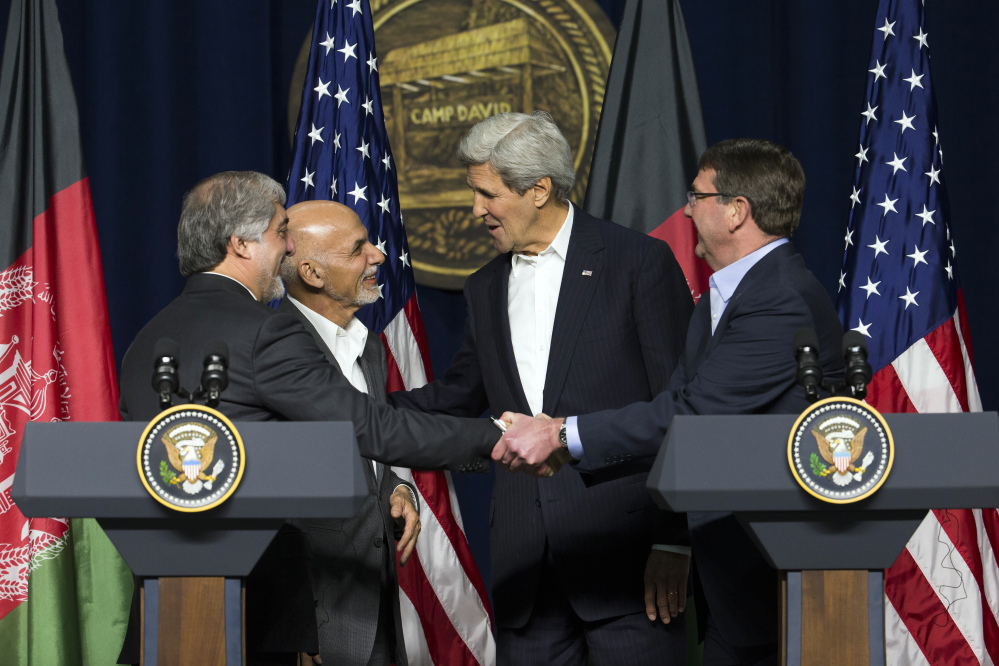 From left, Afghan chief executive Abdullah Abdullah, Afghan President Asraf Ghani, Secretary of State John Kerry and Secretary of Defense Ash Carter shake hands after a news conference at Camp David on Monday. The pace of U.S. troop withdrawals from Afghanistan will headline Ghani’s visit to Washington, yet America’s exit from the war remains linked to the abilities of Afghan forces.