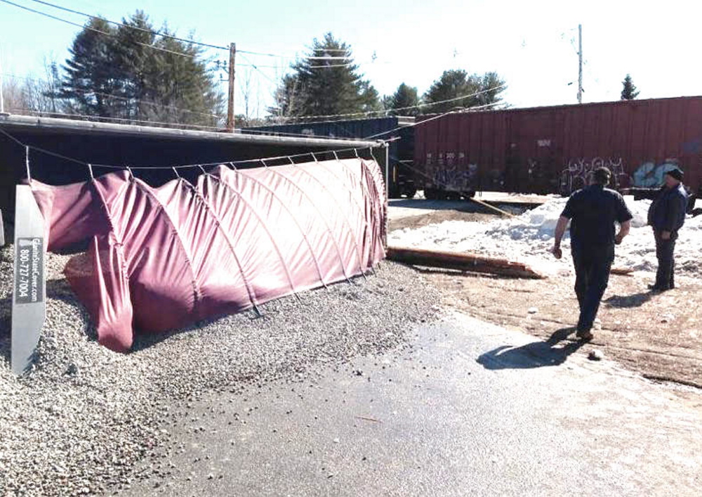 The tractor-trailer spilled its load of gravel after a collision with a train in Auburn on Monday.