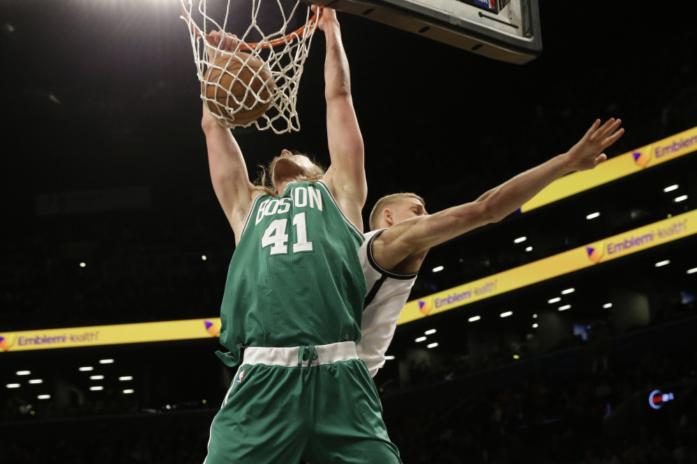 Boston Celtics center Kelly Olynyk dunks against Brooklyn Nets center Mason Plumlee during the second half of Monday night’s win by the Celtics in Brooklyn.