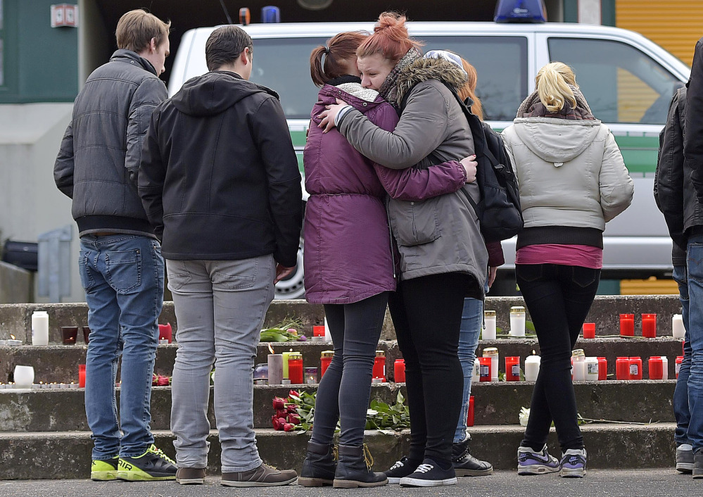 Two girls hug in front of the Joseph-Koenig-Gymnasium in Haltern, western Germany on Tuesday. Among those on the plane were 16 students and two teachers from Haltern.