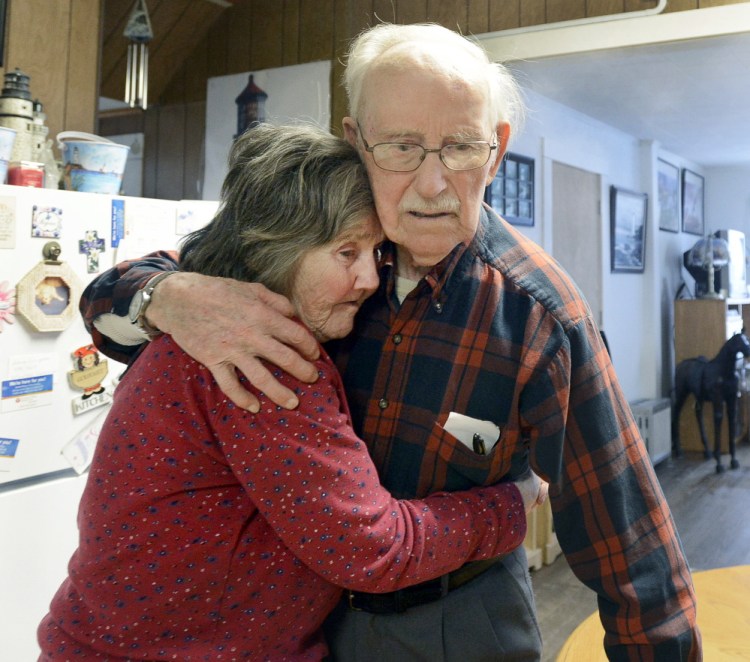 After escaping from an assisted-living center in Sanford on Tuesday, 91-year-old Real L’Heureux embraces 77-year-old Grace Harakles in the kitchen of her Sanford home. To authorities, how L’Heureux managed to leave the locked dementia-care facility remains a mystery. “You find a way,” he said.