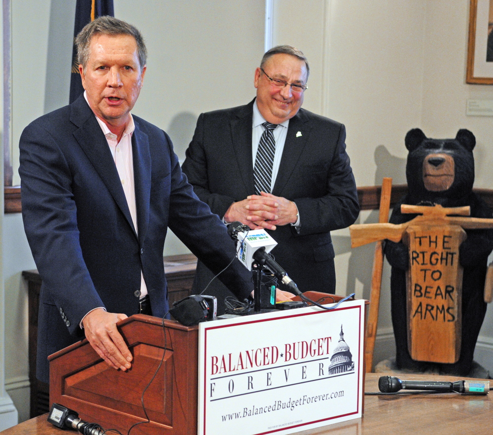 Ohio Republican Gov. John R. Kasich advocates for a constitutional amendment for a national balanced budget at the State House in Augusta on Thursday, with Maine Gov. Paul R. LePage at right.