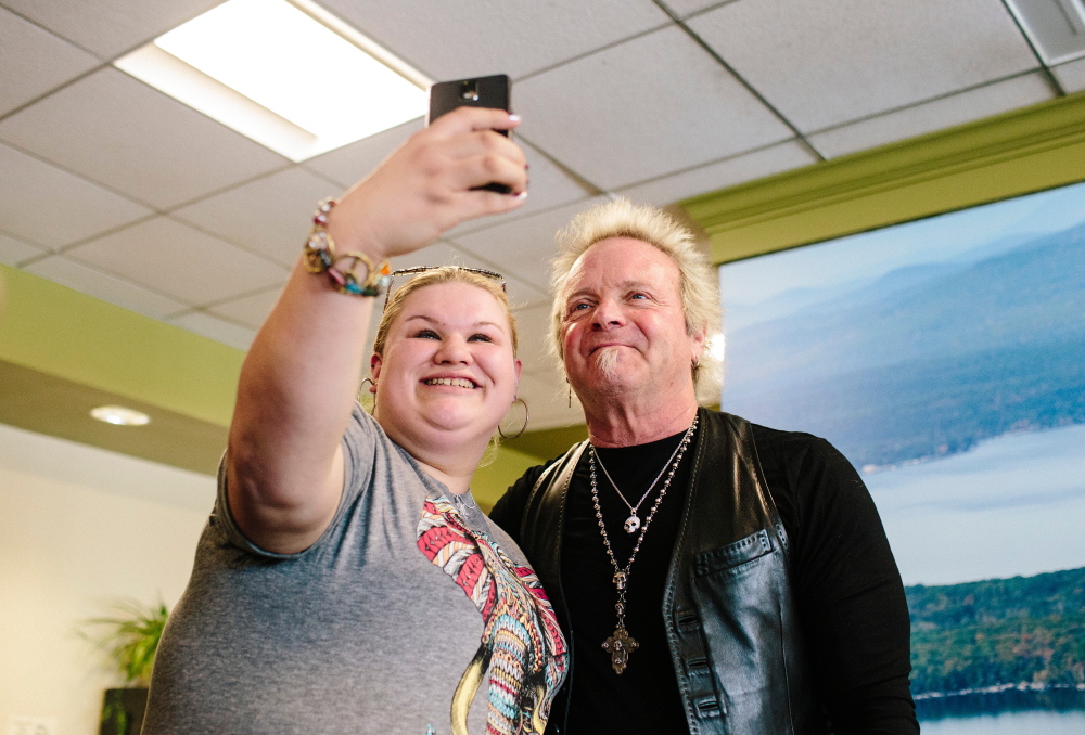 Autumn Johnson holds up her cellphone to take a selfie with Aerosmith drummer Joey Kramer during his visit to St. Joseph’s College in Standish to promote his Rockin’ & Roastin’ coffee on Thursday.