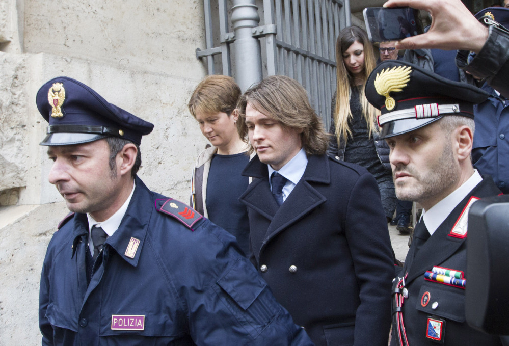 Raffaele Sollecito, center, leaves Italy’s highest court building with his girlfriend, Greta Menegaldo, in Rome on Friday. 