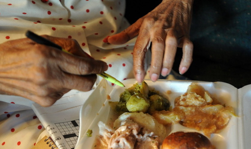 A Charleston, W.Va., woman looks over a meal delivered by the Meals on Wheels program. In Maine, a reduction in federal Meals on Wheels funding will put further pressure on the organizations such as food pantries that help meet the nutrition needs of low-income Mainers.
