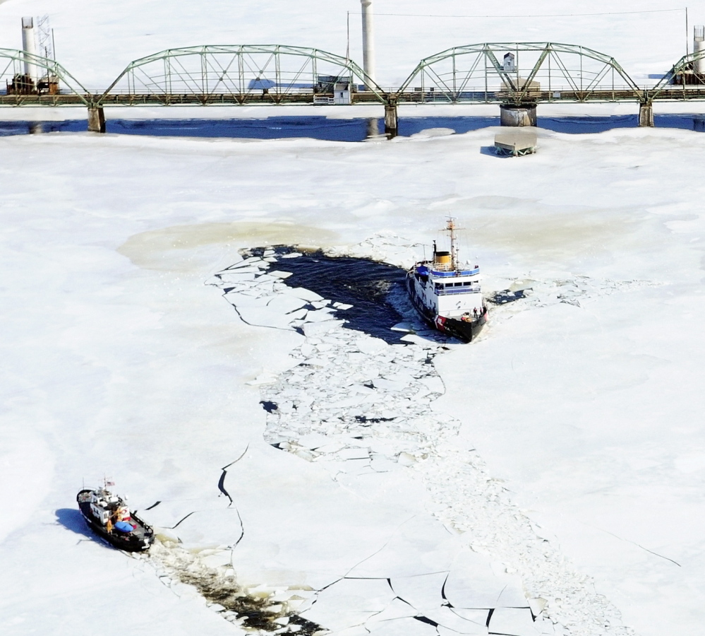 The 65-foot Coast Guard cutter Bridle, left, and the 140-foot Coast Guard cutter Thunder Bay turn around last March near the old Richmond-Dresden Bridge on the Kennebec River.