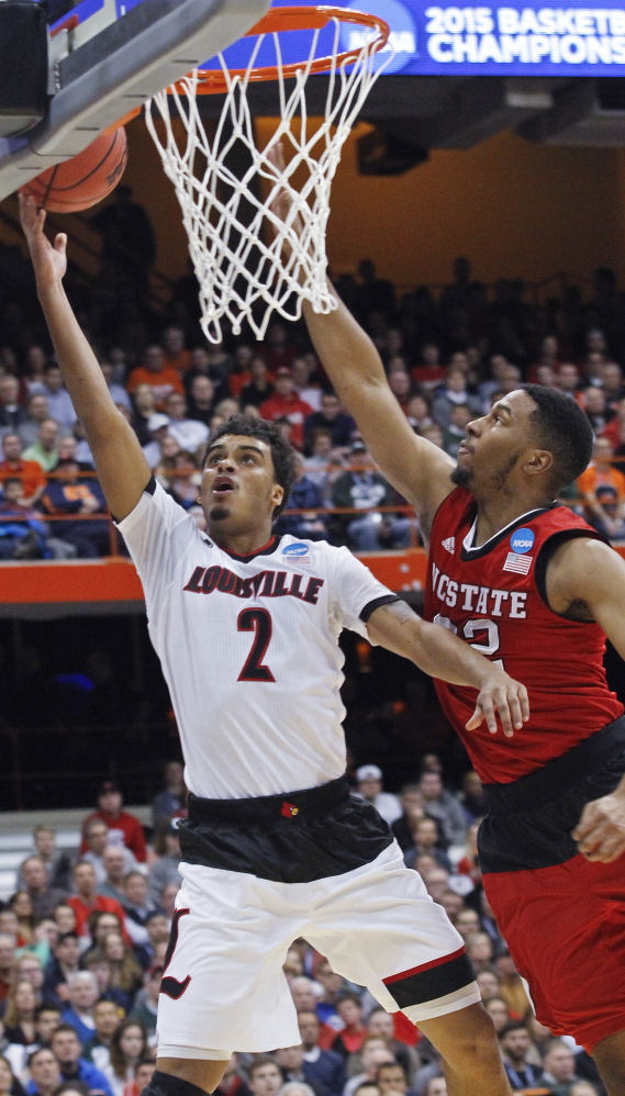 Quentin Snider, who finished with 14 points for Louisville, drives past Ralston Turner of North Carolina State in the first half Friday night.