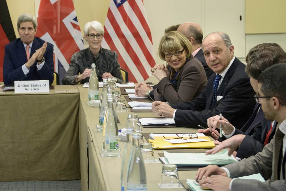 U.S. Secretary of State John Kerry, left, U.S Under Secretary for Political Affairs Wendy Sherman, French Foreign Minister Laurent Fabius, right, and others wait Saturday for the start of a trilateral meeting in Lausanne, Switzerland.