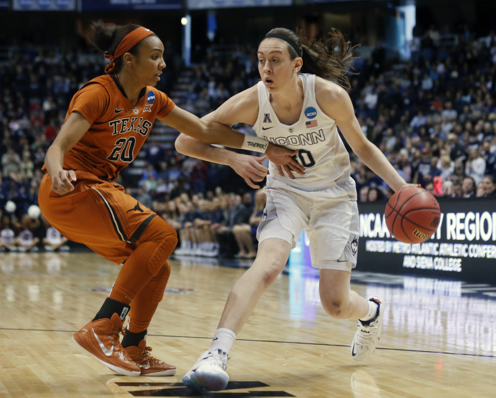 Connecticut forward Breanna Stewart drives against Texas guard Brianna Taylor in Saturday’s regional semifinal game in the NCAA tournament  in Albany, N.Y. Stewart had 31 points, 12 rebounds and seven assists as UConn routed Texas, 105-54.