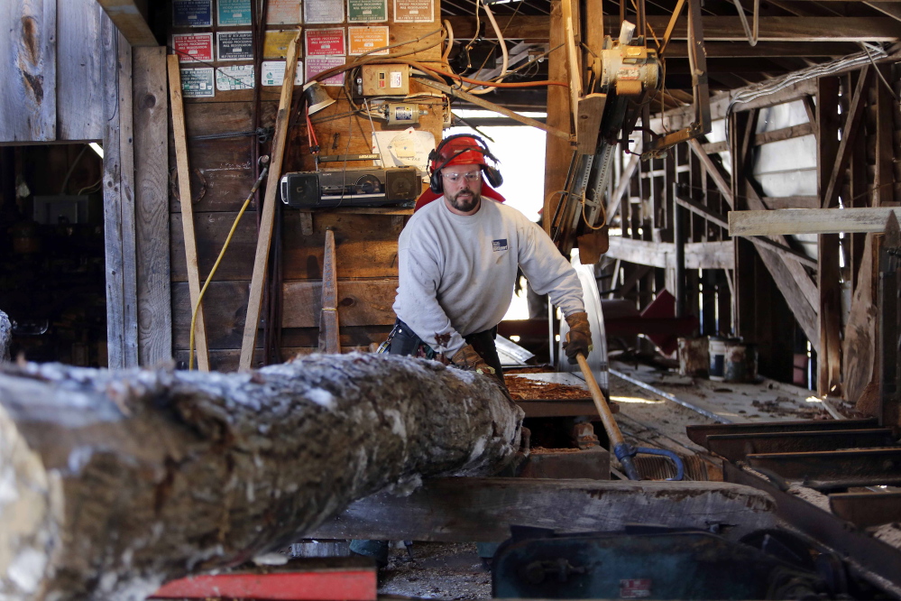 Sawyer Bob Potter wrestles with a log to get it on the carriage at the family saw mill in Gilmanton, N.H. The small family mill, built by his father, has been on Potter’s 250-acre farm since the 1960s but is only used on occasion to cut lumber.